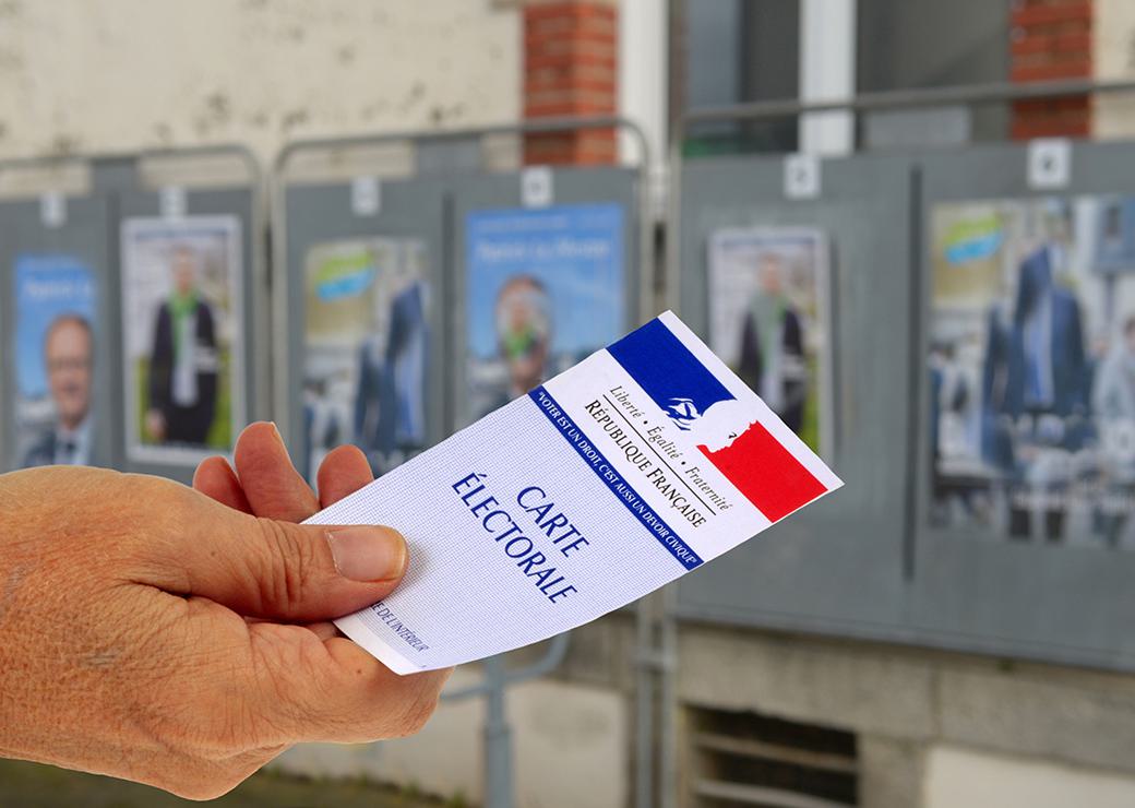 carte electorale devant des panneaux electoraux 